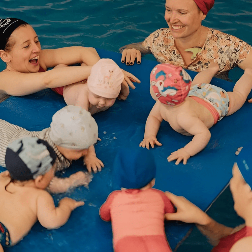 kidtastic baby tummy time on float in pool with parents in circle